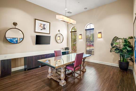 A dining room with a glass table and chairs.