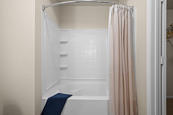 a bathroom with a bathtub and shower with a shower curtain