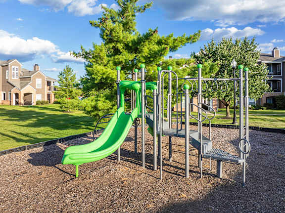 Playgrounds with green slide - Lantern Woods Apartments