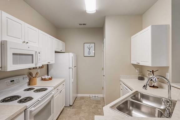 White appliances in select units - Lantern Woods Apartments