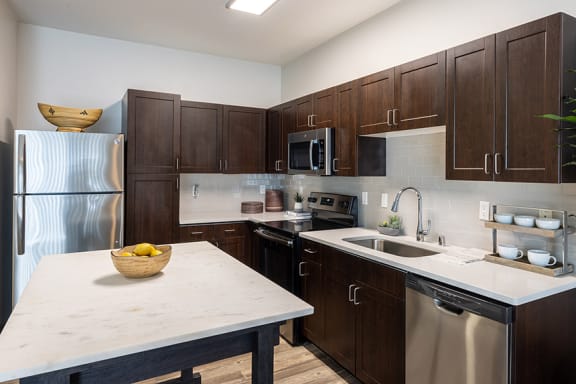 Kitchens with stainless steel or black appliances - ABQ Uptown Apartments