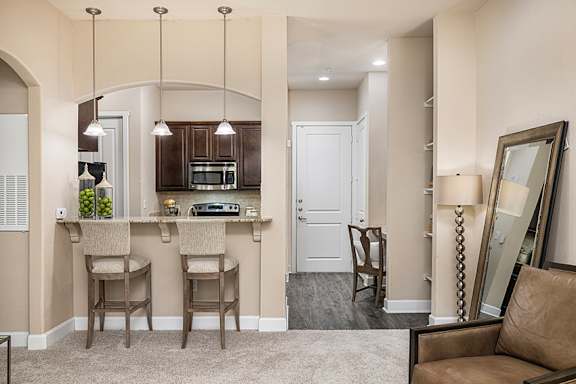 A kitchen with a bar area and a couch.