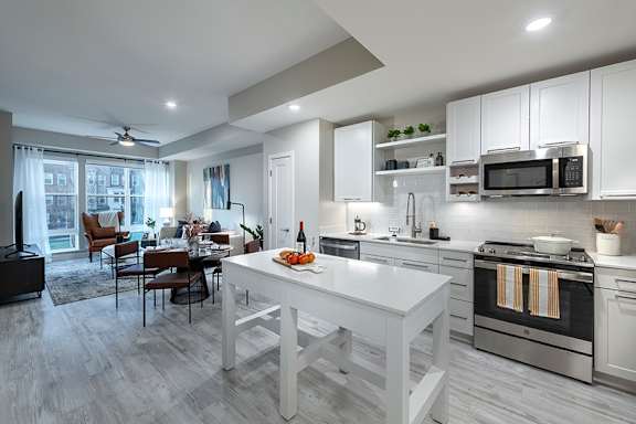 Sleek ash-grey plank flooring in living areas - Rockwell at Crown