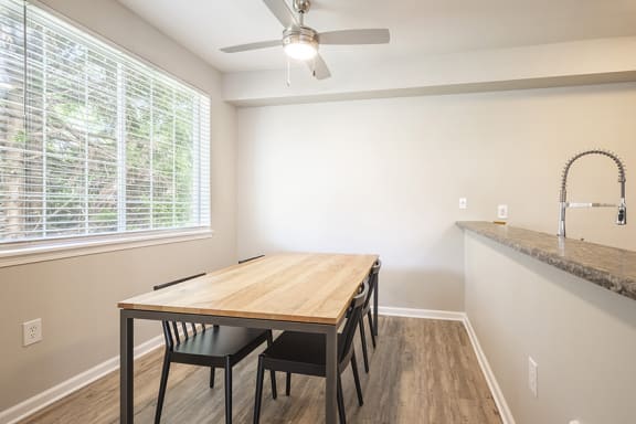 Dining room with lighted ceiling fan - Springbrook Apartments