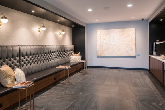 a lobby with a seating area and a painting on the wall