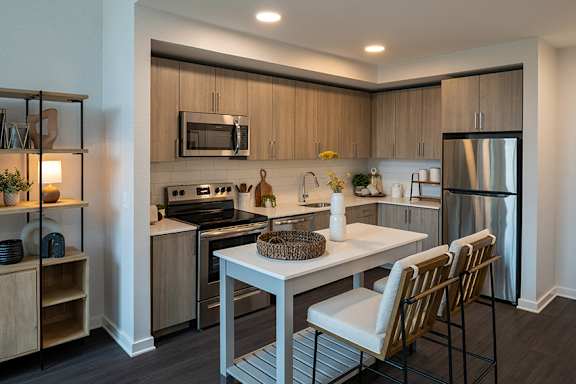 Designer kitchens with quartz countertops and stainless steel appliances - Brentford at the Mile