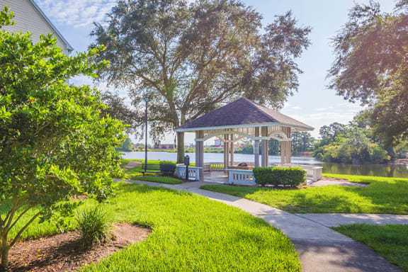 The Colony at Deerwood Apartments - Lakeside gazebo with fire pit and seating area