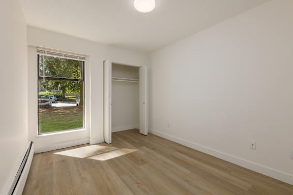 A room with a window and a door.
