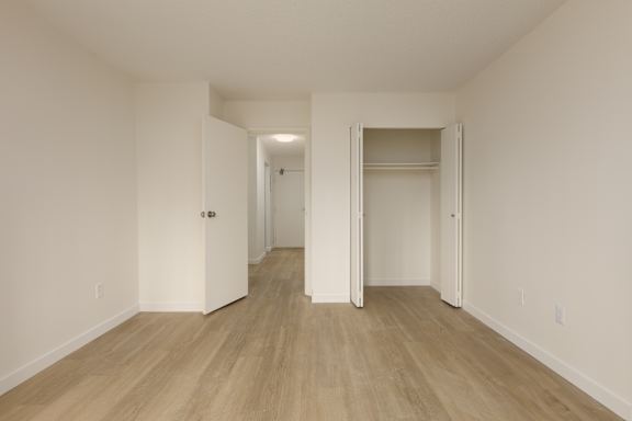 A room with a white door and a white wall.