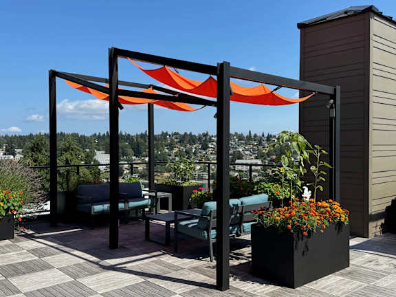 A patio with a table and chairs under a canopy.