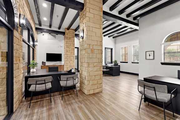 A modern kitchen with a bar area and a dining table.