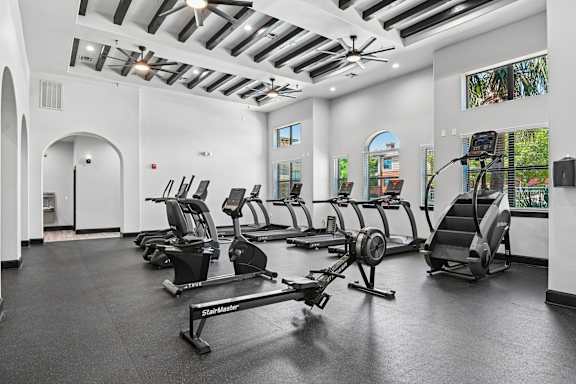 A gym with treadmills and elliptical machines.