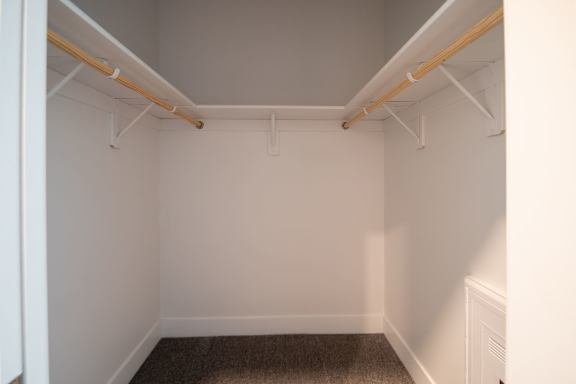 A white room with a brown carpet and white walls.