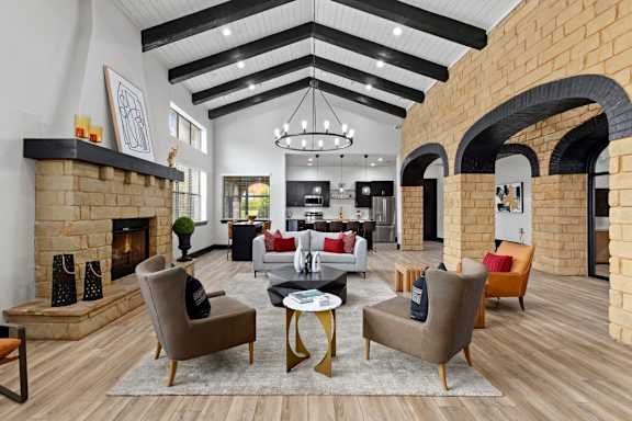 A modern living room with a fireplace and a large chandelier.