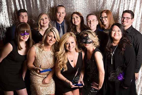 a group of people posing for a photo at a party