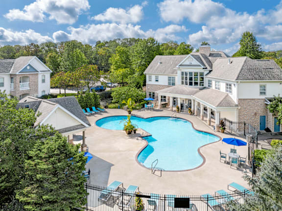 A large house with a pool in the backyard.