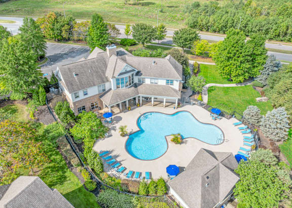 A large house with a pool in the backyard.