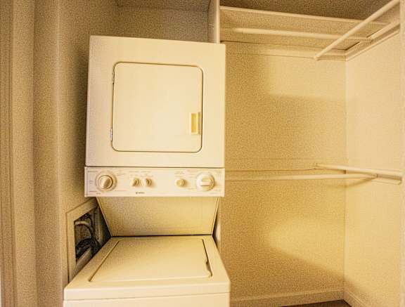 A white oven with a door open is in a room.