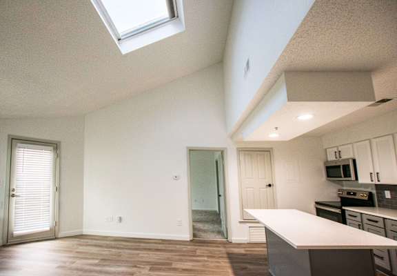A kitchen with a skylight above the counter.