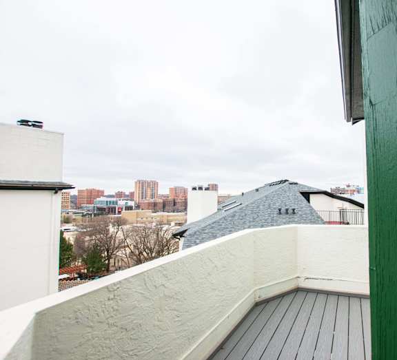 A view from a balcony overlooking a cityscape.