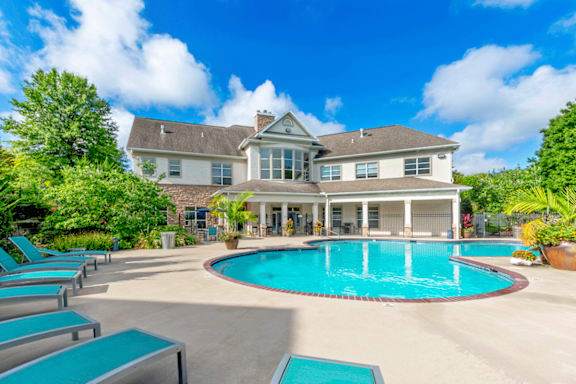 A large house with a pool in the backyard.