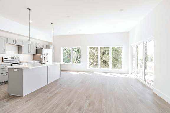 A modern kitchen with white cabinets and a large island.