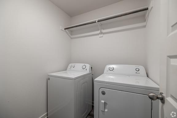Two washing machines in a small laundry room.