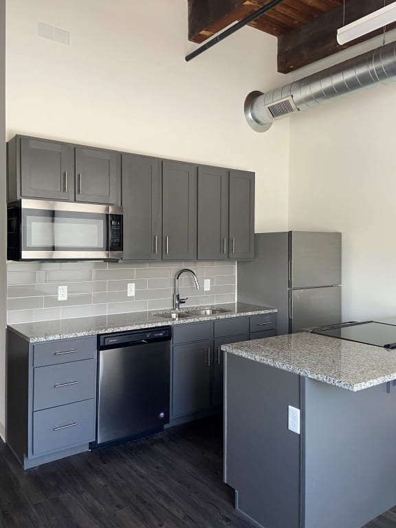 a kitchen with granite counter tops and stainless steel appliances