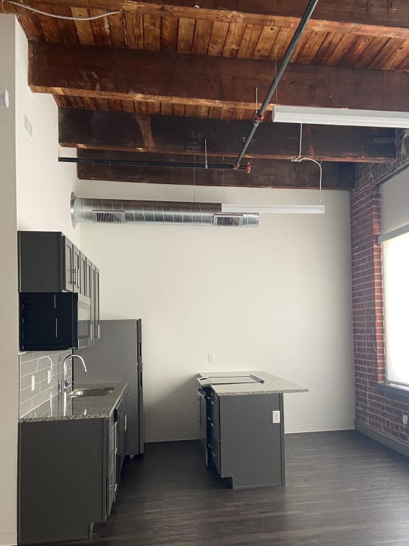 an empty kitchen in a room with a sink and appliances
