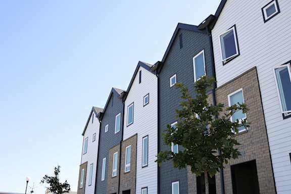 Three different floor plans of a house with a car parked in the driveway.