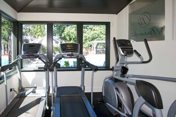 A gym with treadmills and exercise bikes.