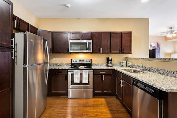 A kitchen with a stainless steel refrigerator and oven.
