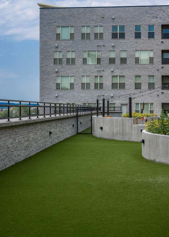 A building with a green lawn in front.