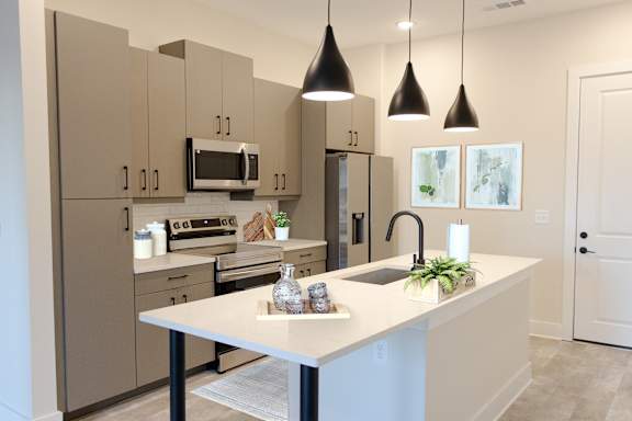 A kitchen with a white countertop and brown cabinets.at Riverside Apartments, Chattanooga, Tennessee