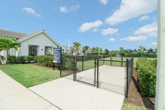 a fenced in yard with a house in the background at The Crest at Naples, Florida