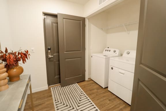 a small laundry room with a washer and dryer at The Crest at Naples, Naples, FL, 34113