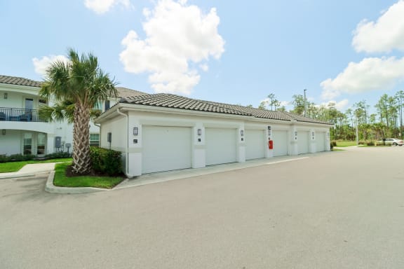 a house with a palm tree in front of it at The Crest at Naples, Naples, FL, 34113