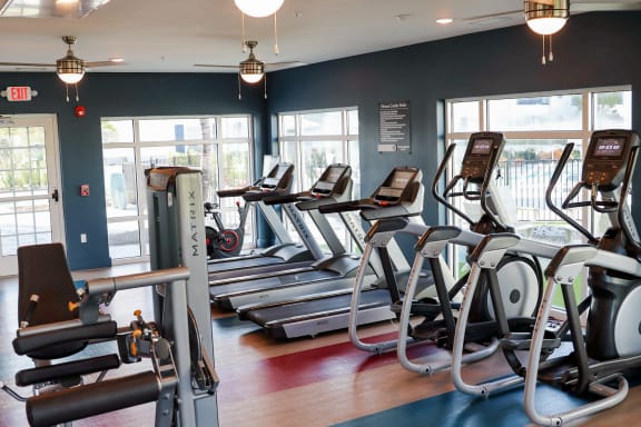 a row of treadmills and elliptical trainers in a gym at The Crest at Naples, Florida