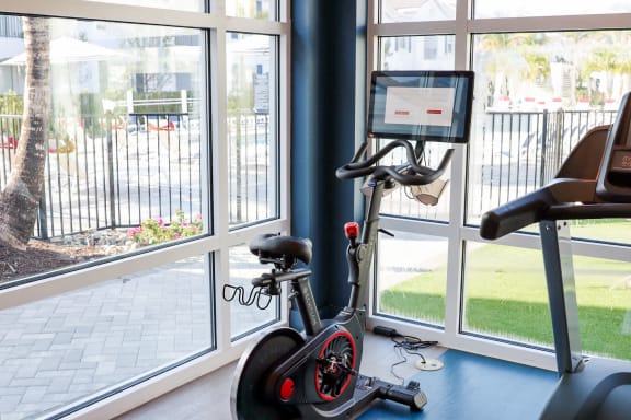 a home gym with a bike in front of a window at The Crest at Naples, Naples