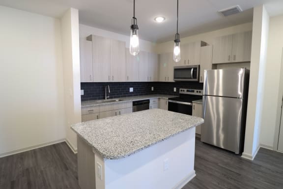 a kitchen with white cabinets and a granite counter top at The Crest at Acworth, Acworth, 30102