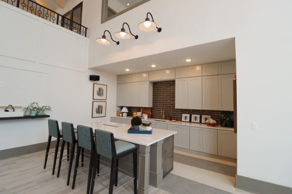 a kitchen with white cabinets and a large island with a white countertop at The Crest at Acworth, Georgia, 30102