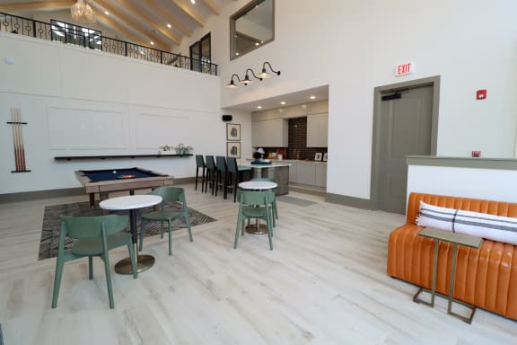 a seating area with tables and chairs and a pool table in the center of the room at The Crest at Acworth, Georgia, 30102