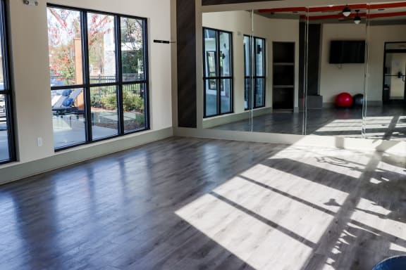 an empty living room with wood floors and large windows at The Crest at Laurel Canyon, Canton