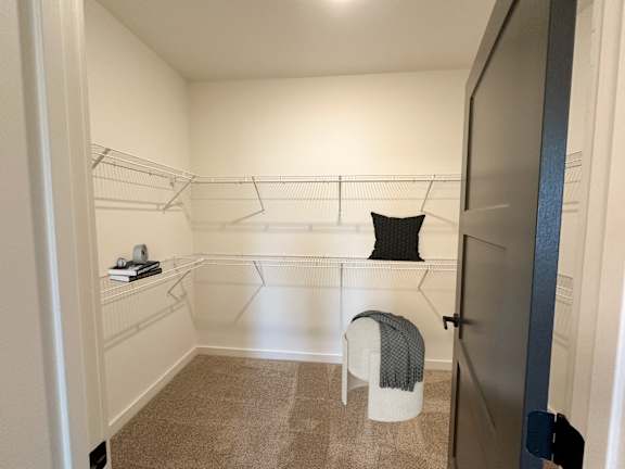 A small, empty room with a chair and a shelf.