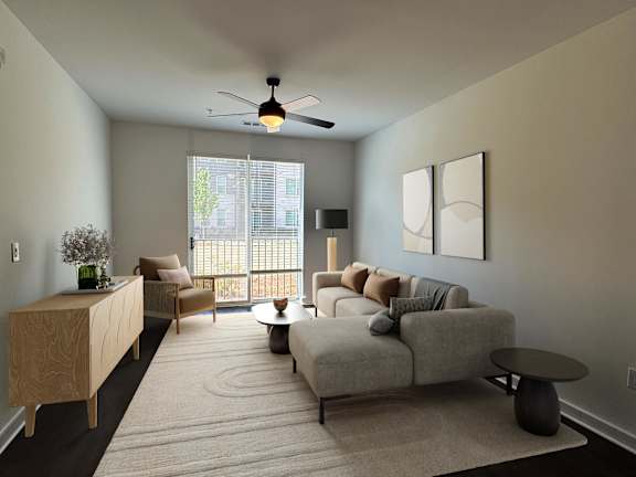 A living room with a grey couch, a wooden cabinet, a chair, a table, and a ceiling fan.