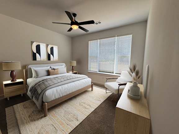 A bedroom with a bed, chair, and a fan.