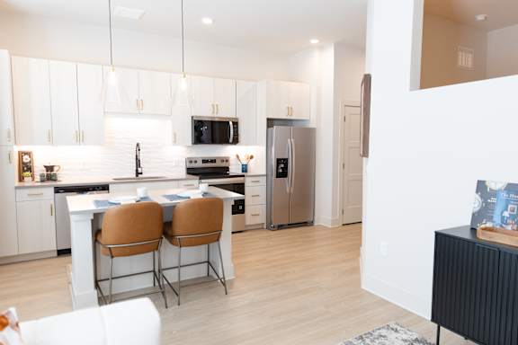 Bright minimalist kitchen with Table and Chairs at District on the Etowah Apartments, Canton, 30114
