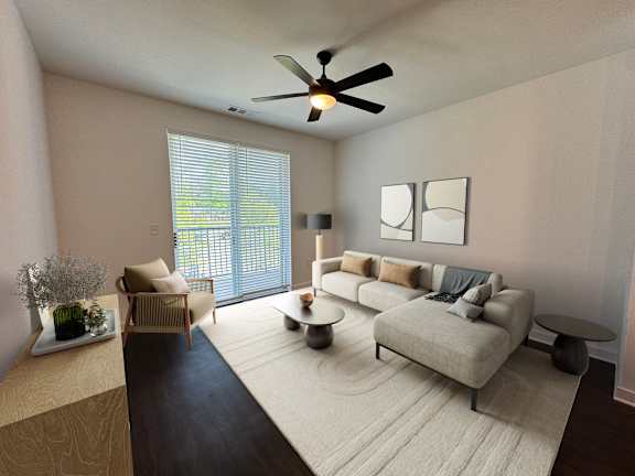 A living room with a grey sofa, a wooden table, and a ceiling fan.