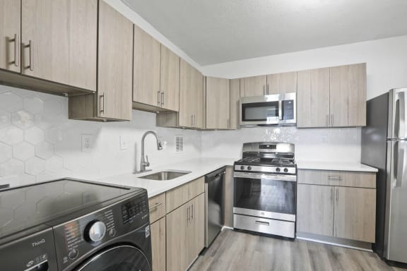 Skyline Towers kitchen with stainless appliances and hardwood-inspired flooring