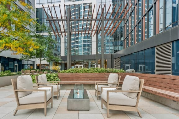 outdoor fireside lounging area with comfortable seating at Via Seaport apartments in Boston